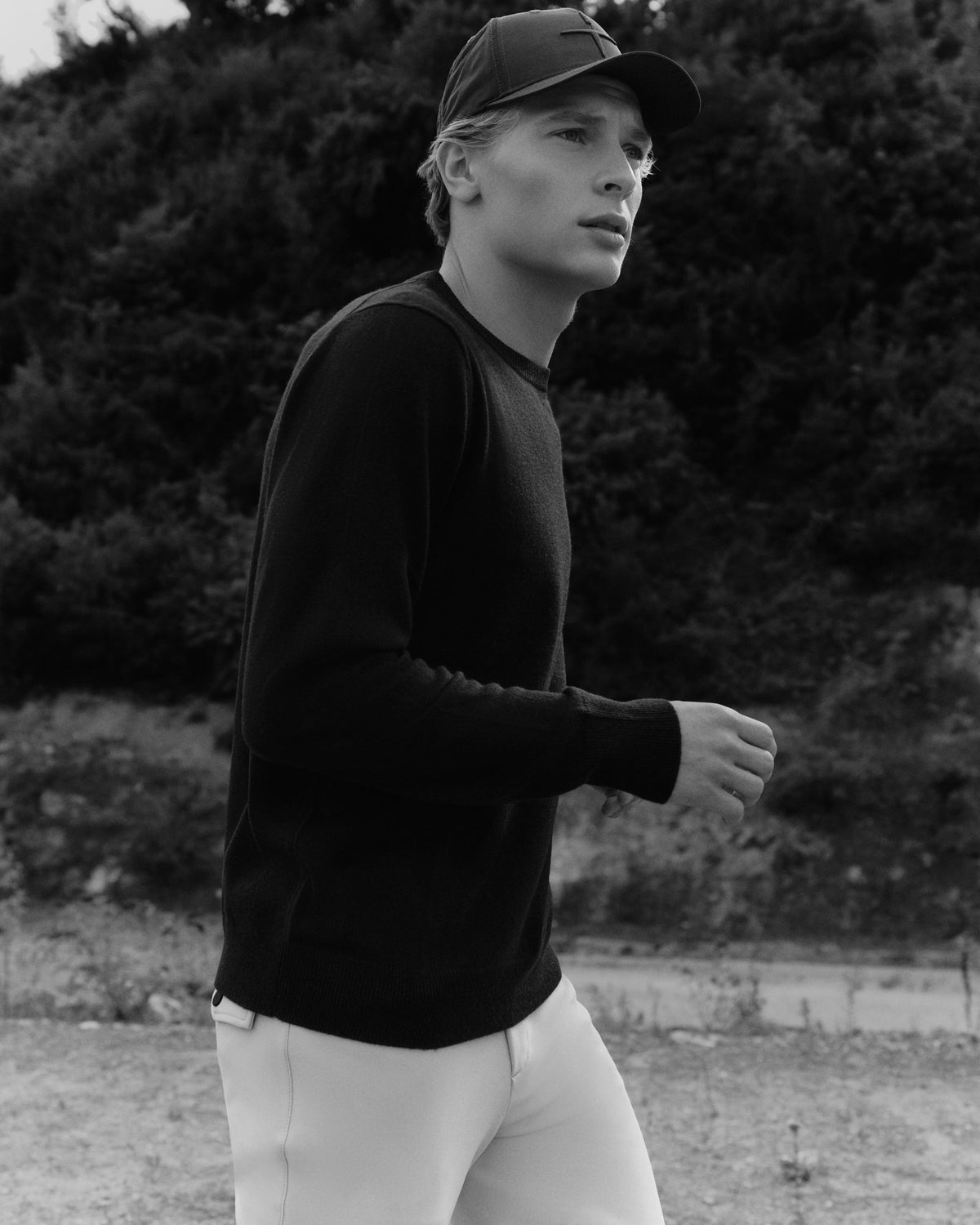 Tonal Fine Cashmere Logo Crew Sweater in navy, worn at Faxe Kalkbrud in a black-and-white AW26 campaign photograph.