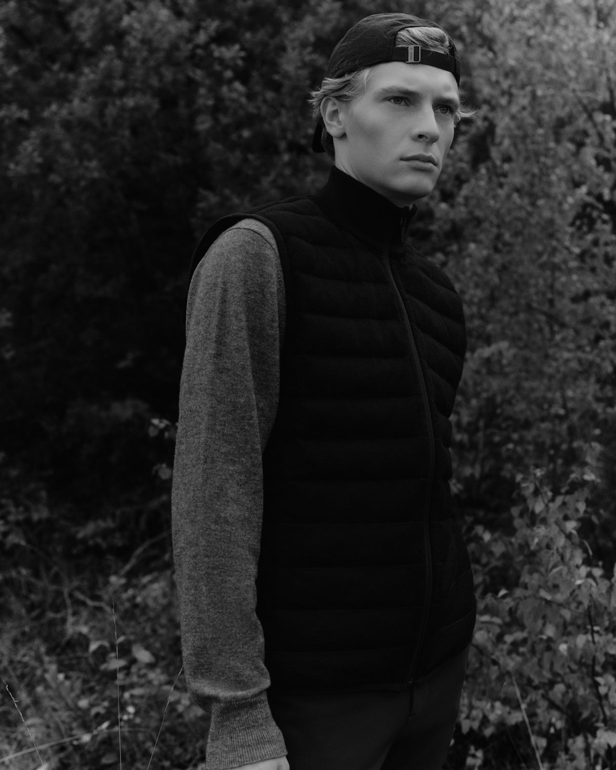 Flower Down reversible vest in black, layered over knitwear at Faxe Kalkbrud for the Trolle Projects AW26 campaign.