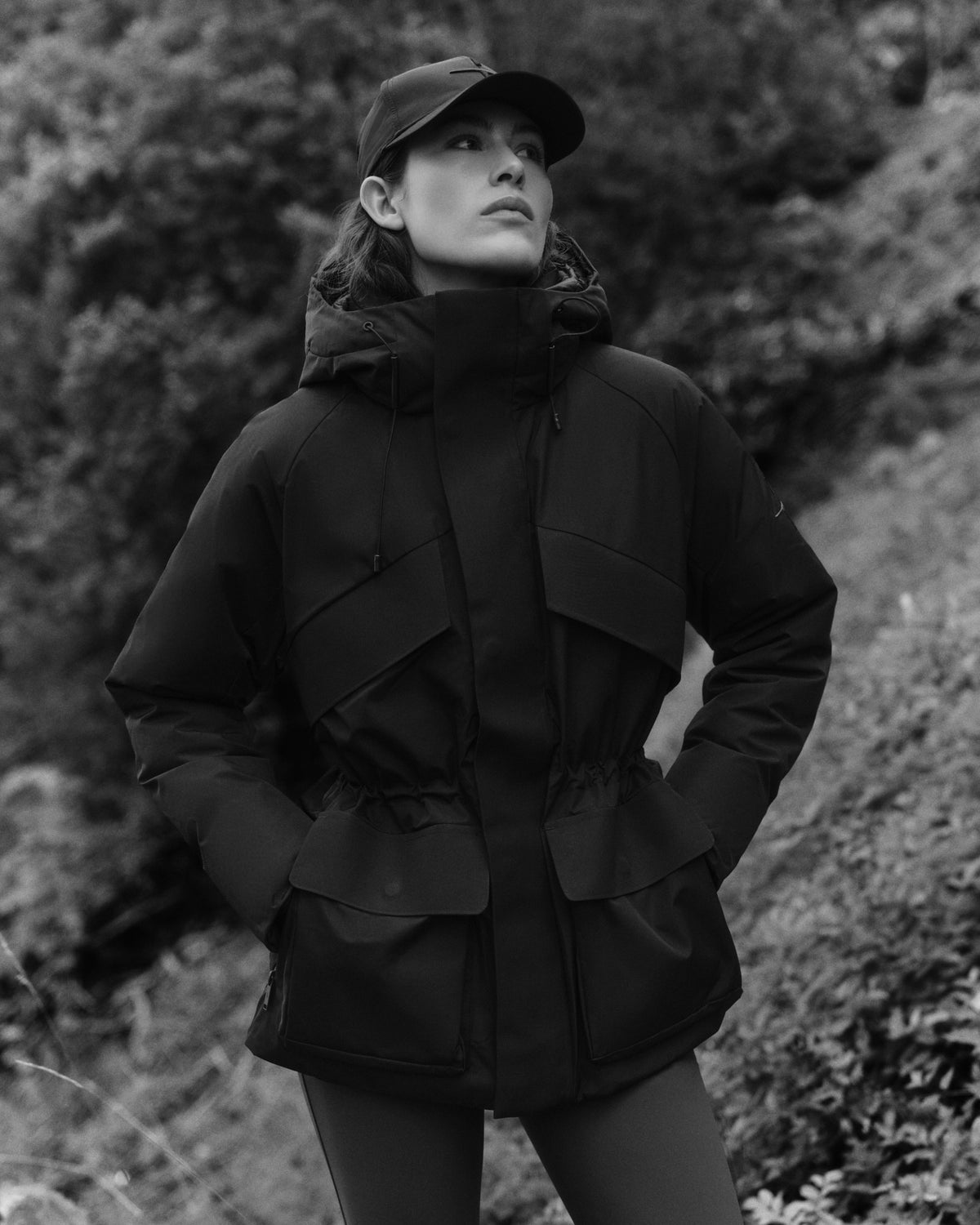 Black-and-white portrait in a hooded black jacket at Faxe Kalkbrud.